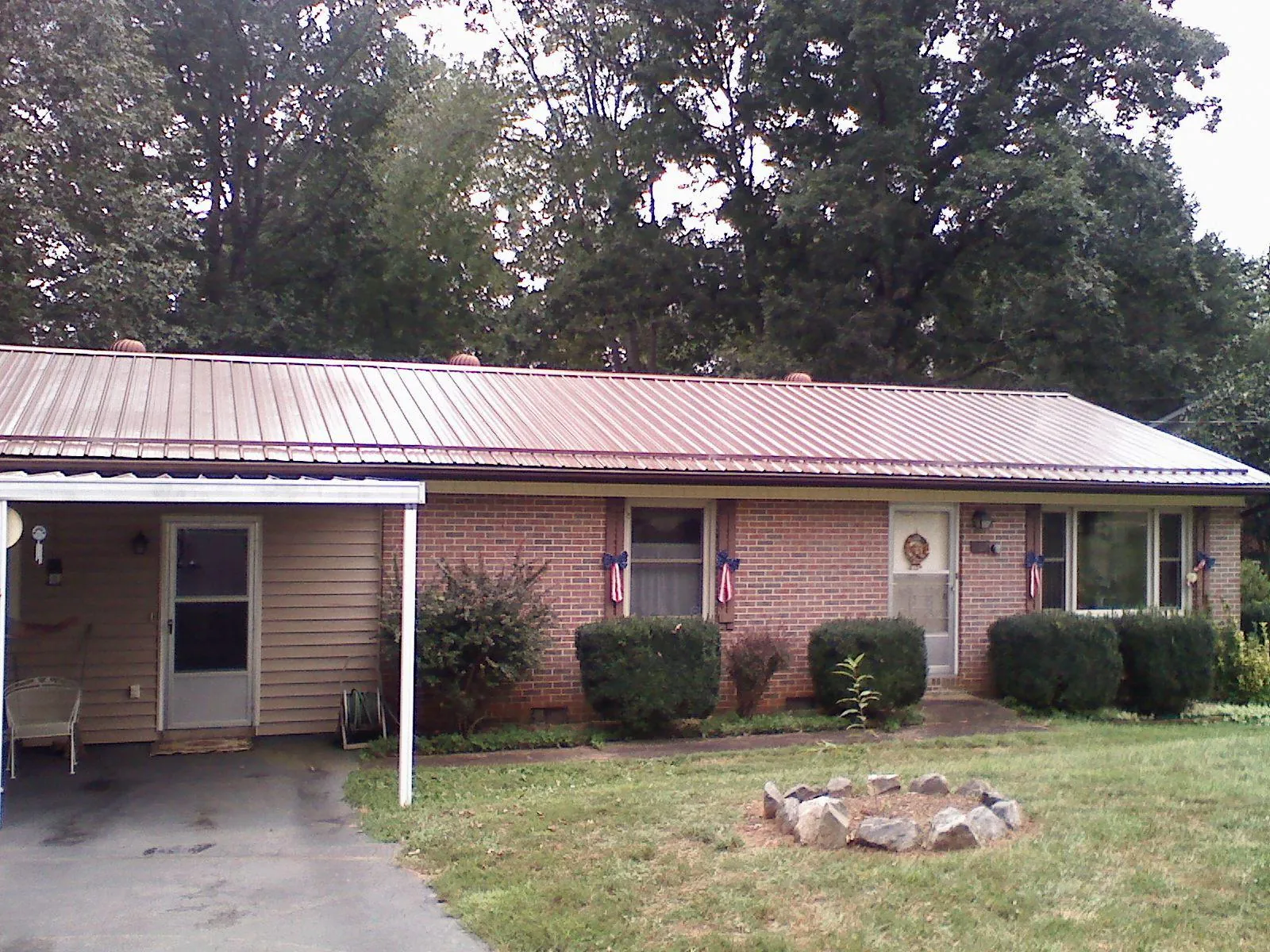 Bronze metal roof and carport on a brick ranch home — Roof Repair work by our crew in Roseland